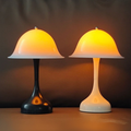 Retro mushroom-style table lamp with curved dome shade and sleek base, available in black or white, warm ambient glow for modern bedrooms, desks, or living rooms