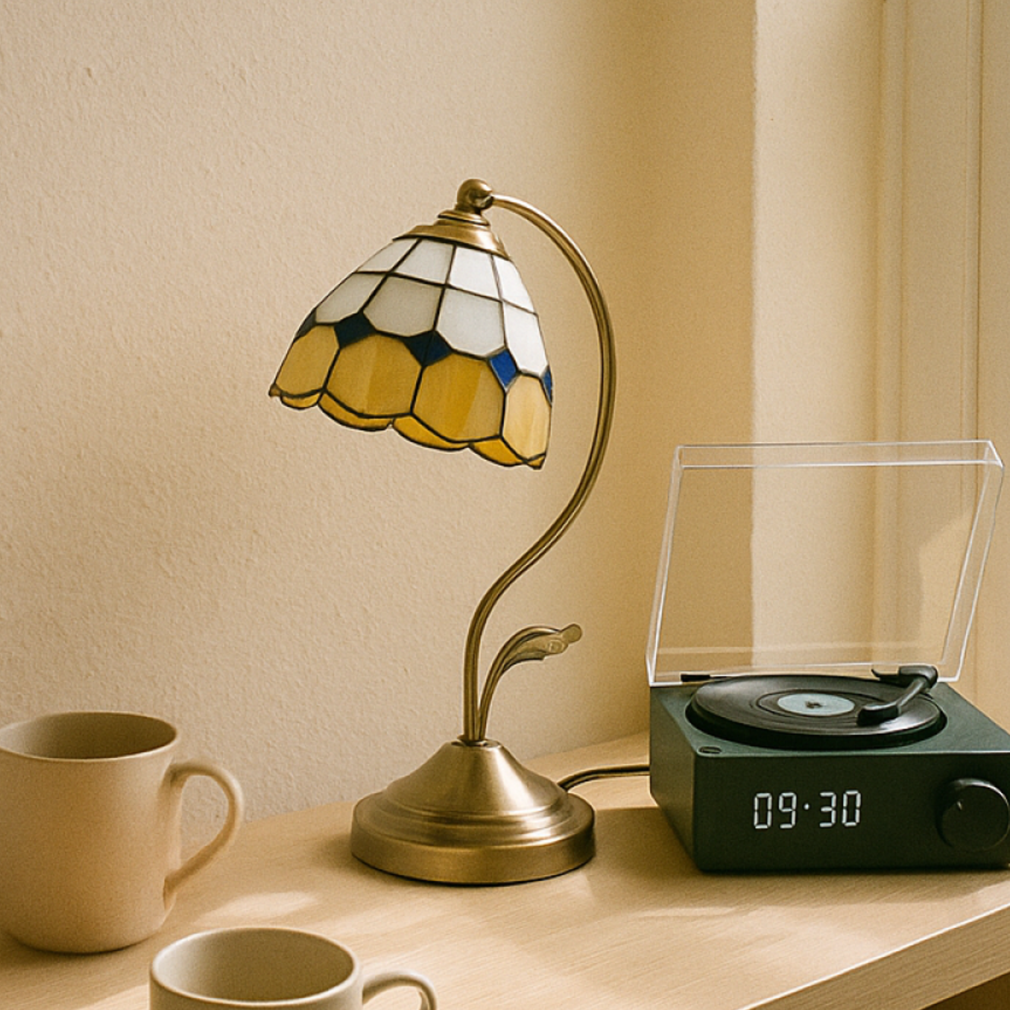 Vintage Tiffany-inspired lamp with curved stand, warm golden glow for cosy rooms