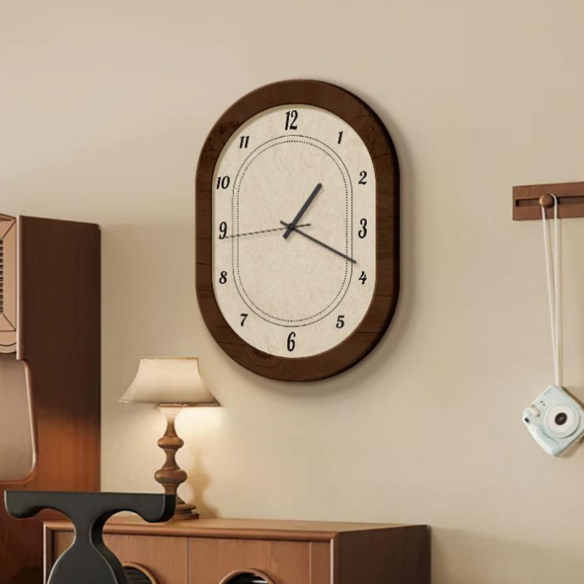 Retro oval wall clock with dark wooden frame and cream face, minimalist numbers and hands, perfect for adding vintage charm to living rooms, bedrooms, or home offices