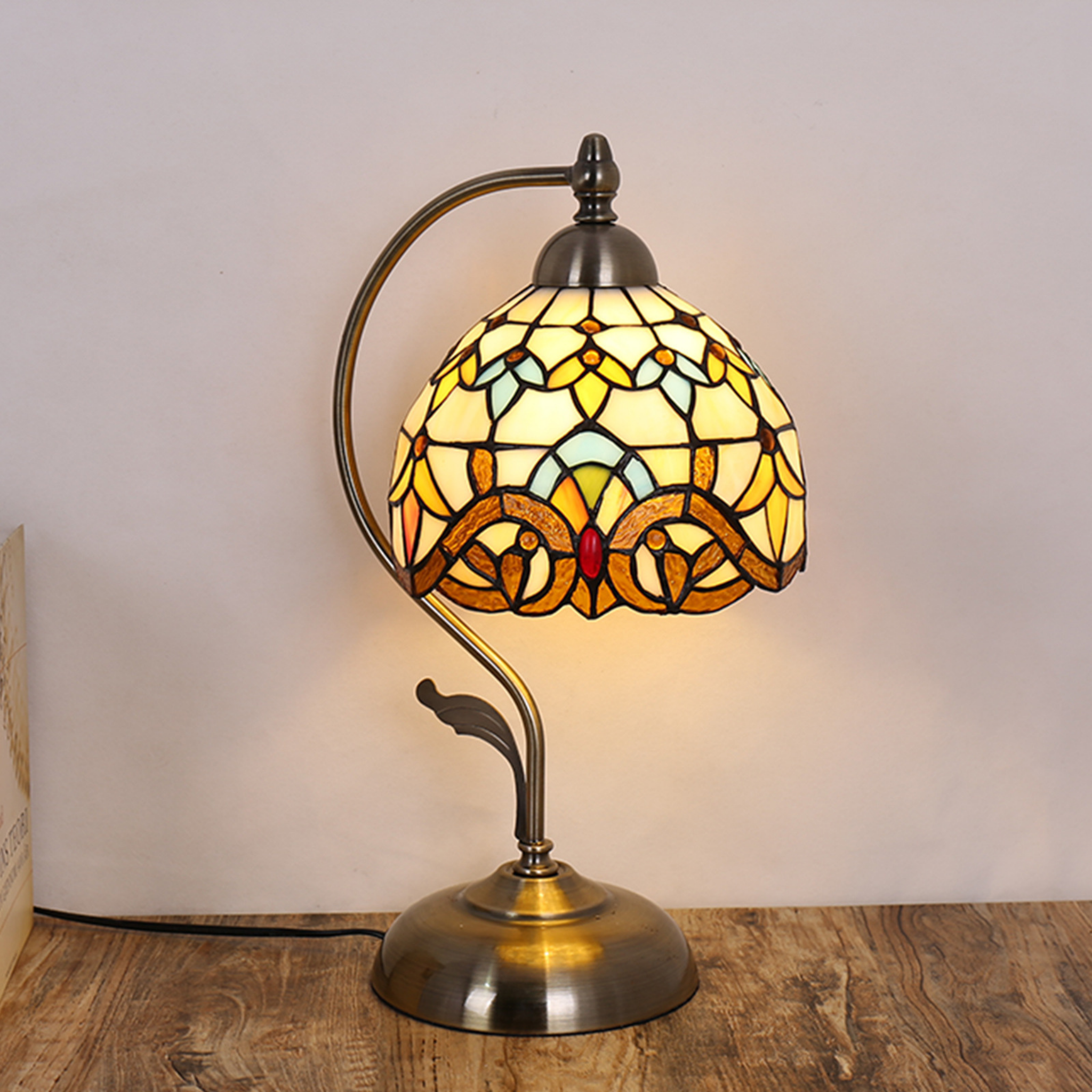 Amber Grace Lamp illuminated in warm golden tones, showcasing intricate stained glass craftsmanship and vintage charm — KaShi Living home décor lighting