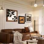 A cosy UK living room styled with Botanica framed wall art above a brown sofa, designed for warm neutral interiors and modern gallery wall styling.