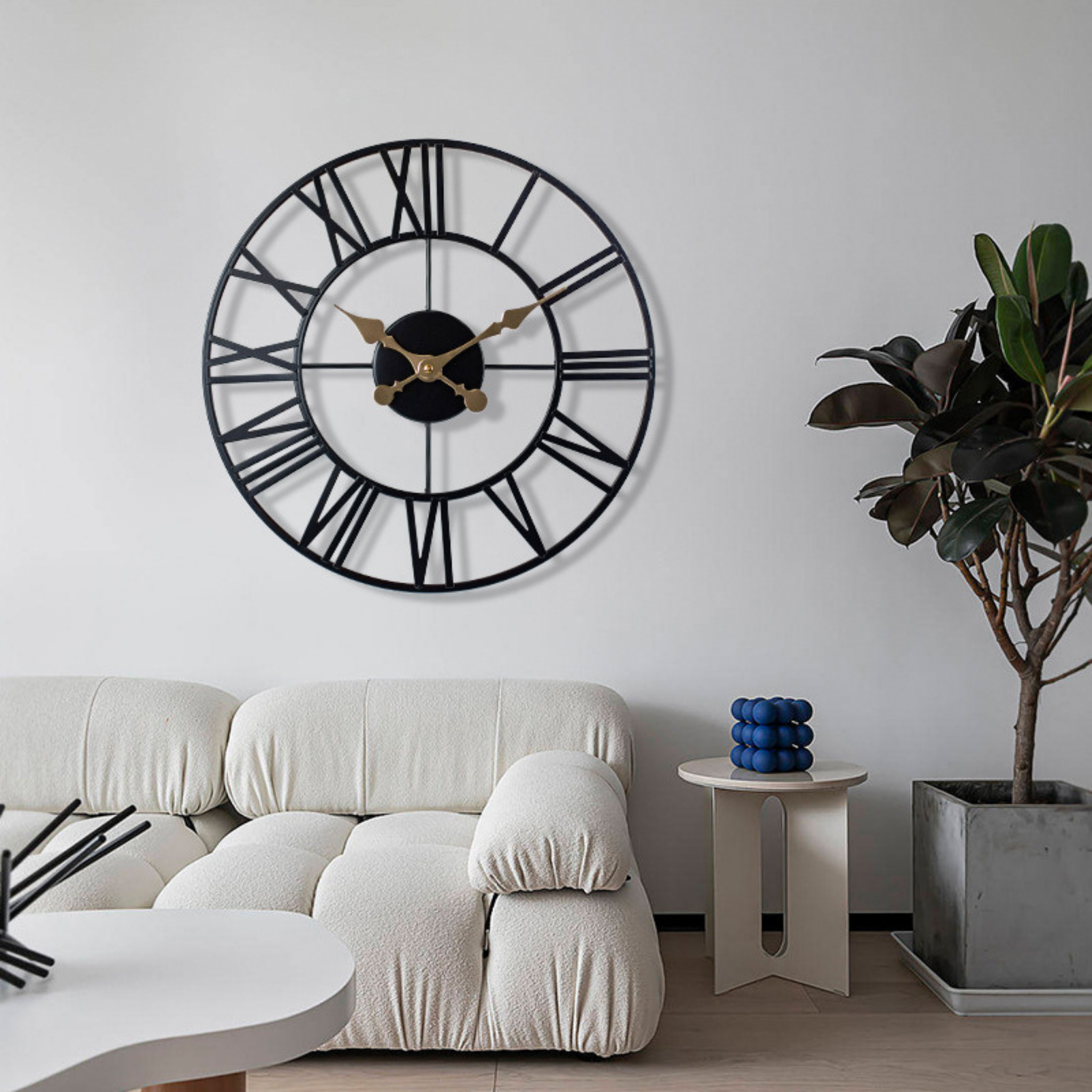 Cambridge Roman Clock styled above cream sofa — minimalist black and gold wall clock adding timeless charm to modern interiors, KaShi Living