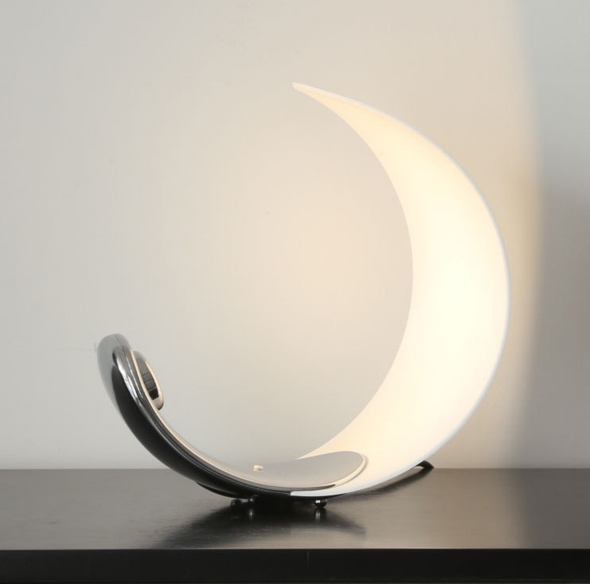 Eclipse Arc Lamp illuminated — crescent design radiating warm light, ideal for bedrooms or creative spaces, KaShi Living modern lighting