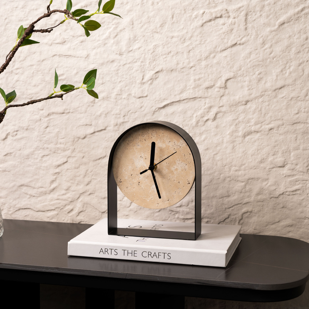 A stone-effect arched table clock with a black frame for UK shelves, desks, bedside tables, mantelpieces and warm minimalist home décor.
