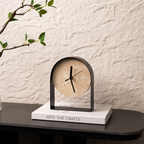 A stone-effect arched table clock with a black frame for UK shelves, desks, bedside tables, mantelpieces and warm minimalist home décor.