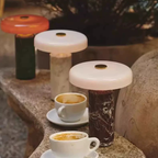 A rechargeable portable table lamp with a wide disc shade and stone-effect base, ideal for bedside tables, desks and living rooms.