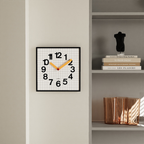 A playful square wall clock with a grid face, bold numbers and yellow hands for bedrooms, living rooms and home offices.