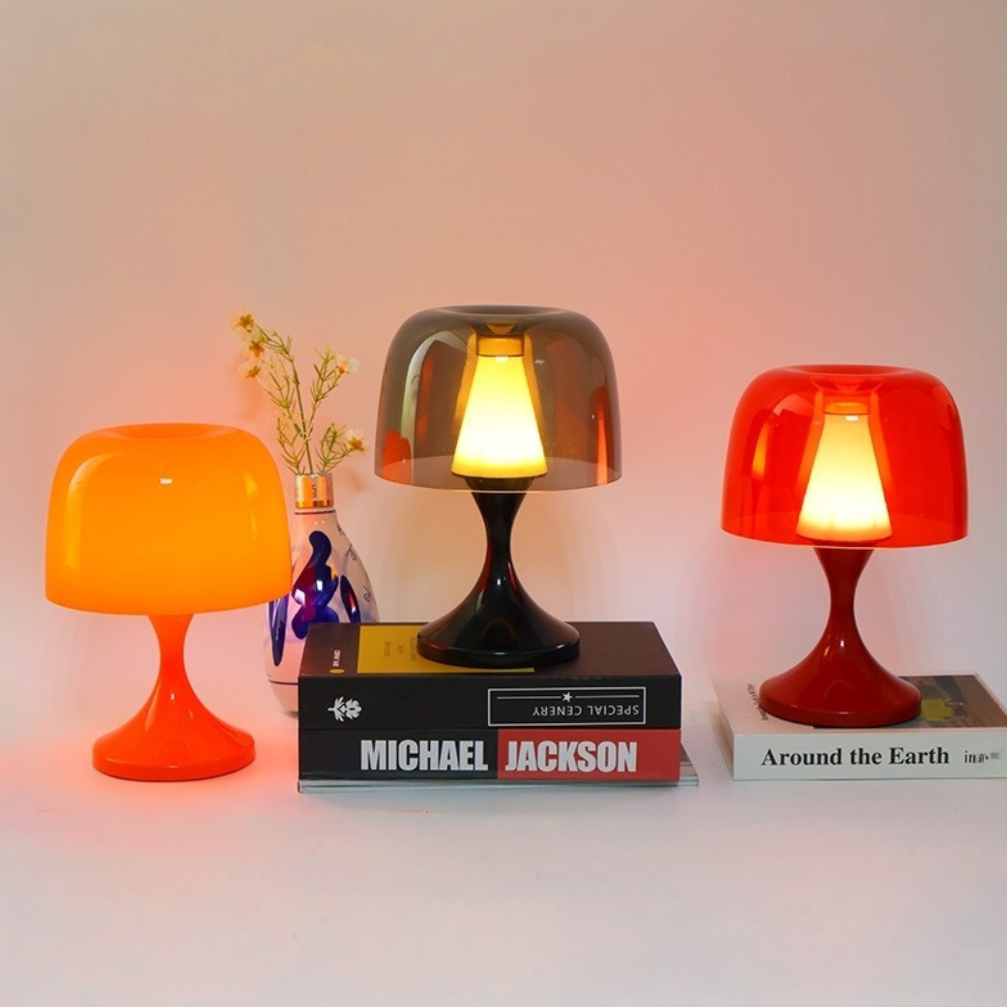 A portable dome black red orange table lamp for bedrooms, desks, bedside tables and cosy living room corners. Available in warm modern colours.