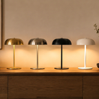 A modern dome table lamp for bedside tables, desks and cosy living spaces, available in gold, black, white and silver.