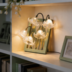 A clear floral table lamp with bell-shaped flower shades for UK bedrooms, bedside tables, desks and cosy living room corners.