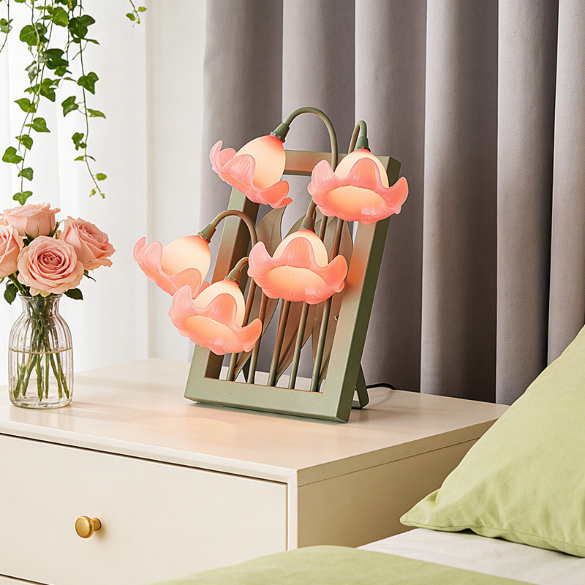 A pink floral table lamp with bell-shaped flower shades for UK bedrooms, bedside tables, desks and cosy living room corners.