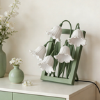 A white floral table lamp with soft bell-shaped shades, perfect for cosy bedrooms, bedside tables and living room corners.