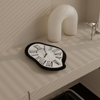 A black and white melted Roman wall clock for playful living room, bedroom, hallway or home office wall décor.