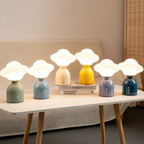 A soft cloud-style portable table lamp with a glossy rounded base, ideal for UK bedrooms, bedside tables, desks and cosy living room corners.