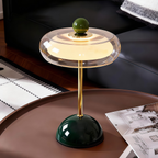A colourful portable table lamp with a glossy round base, slim stem and softly glowing rounded shade, ideal for UK bedrooms, desks and living rooms.