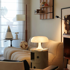 White Orla Halo Table Lamp glowing on a side table beside a curved cream sofa in a cosy living room – KaShi Living