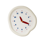 A soft ivory pebble wall clock with blue numbers and red hands, ideal for bedrooms, kitchens, hallways and cosy living rooms.