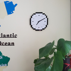 A modern black and white wall clock with a pixel-style edge, ideal for bedrooms, offices, kitchens and living rooms.