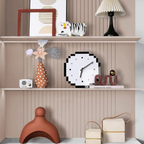 Decorative shelf with various items including a pixel art clock against a striped wall.