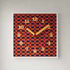 A bold square checkerboard wall clock with warm retro colour, ideal for kitchens, bedrooms, living rooms and gallery walls.