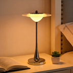 A sculptural ripple table lamp with a slim polished stem, ideal for bedside tables, desks and cosy living room corners.