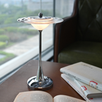 The Serena Ripple Table Lamp is a sculptural table lamp with a rippled shade and slim polished base, suited to UK bedrooms, desks, side tables and cosy living room corners.