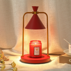 Sienna Crimson Cone Candle Warmer Lamp with a red shade, red base and gold frame, warming a red jar candle in a cosy interior.