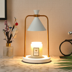 Sienna Ivory Cone Candle Warmer Lamp with a white shade, white base and gold frame, styled with a jar candle on a marble surface.