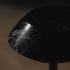 Close-up of a textured black stone  portable table lamp