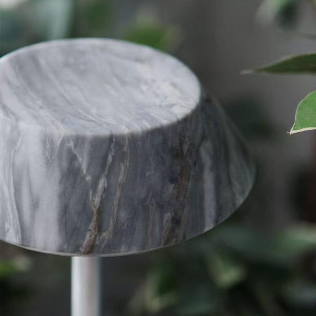 Close-up of a textured dark grey stone  portable table lamp