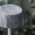Close-up of a textured dark grey stone  portable table lamp