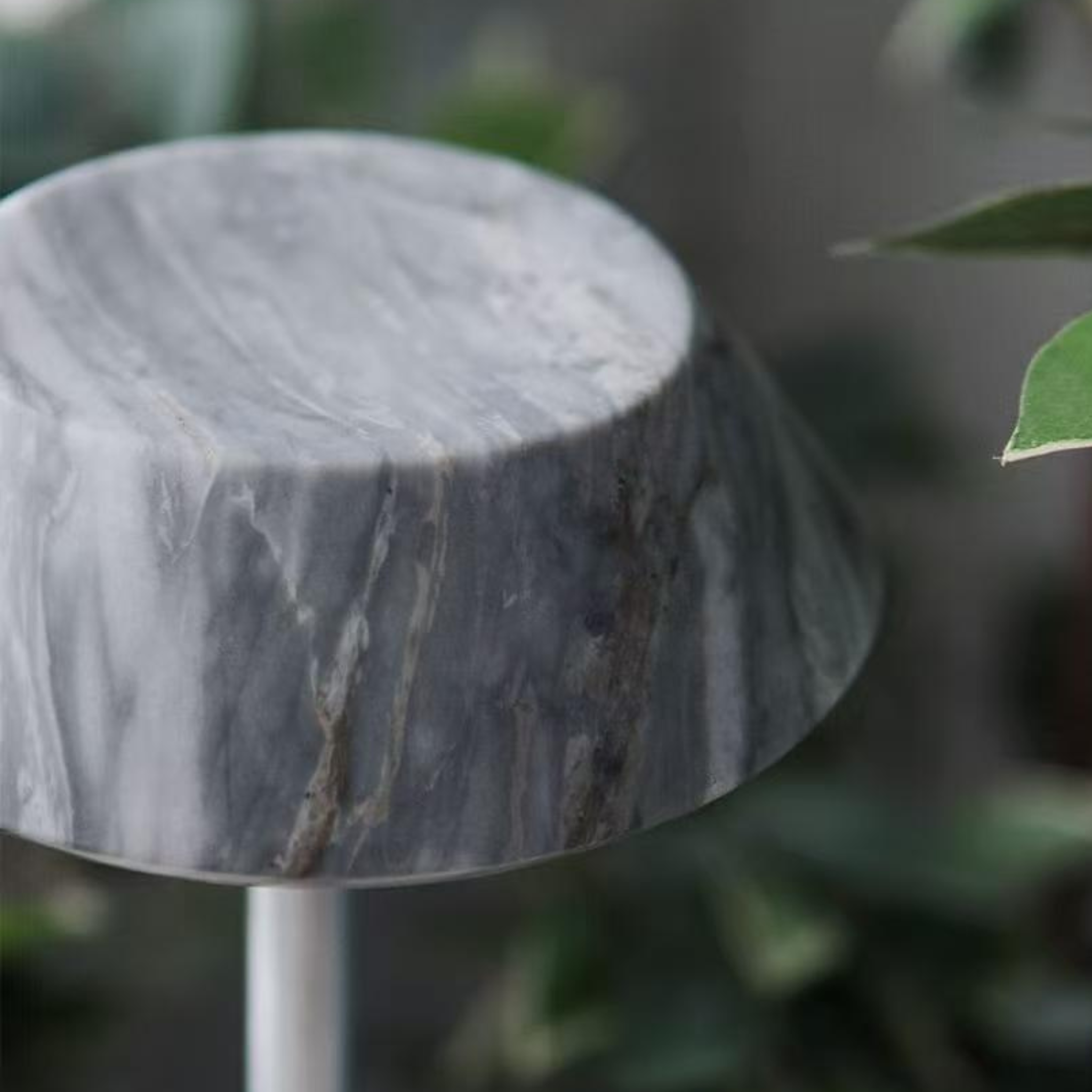 Close-up of a textured dark grey stone  portable table lamp
