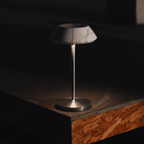 A stone-effect portable table lamp with a slim metallic stem and soft shade, ideal for UK bedside tables, desks and cosy living room corners.