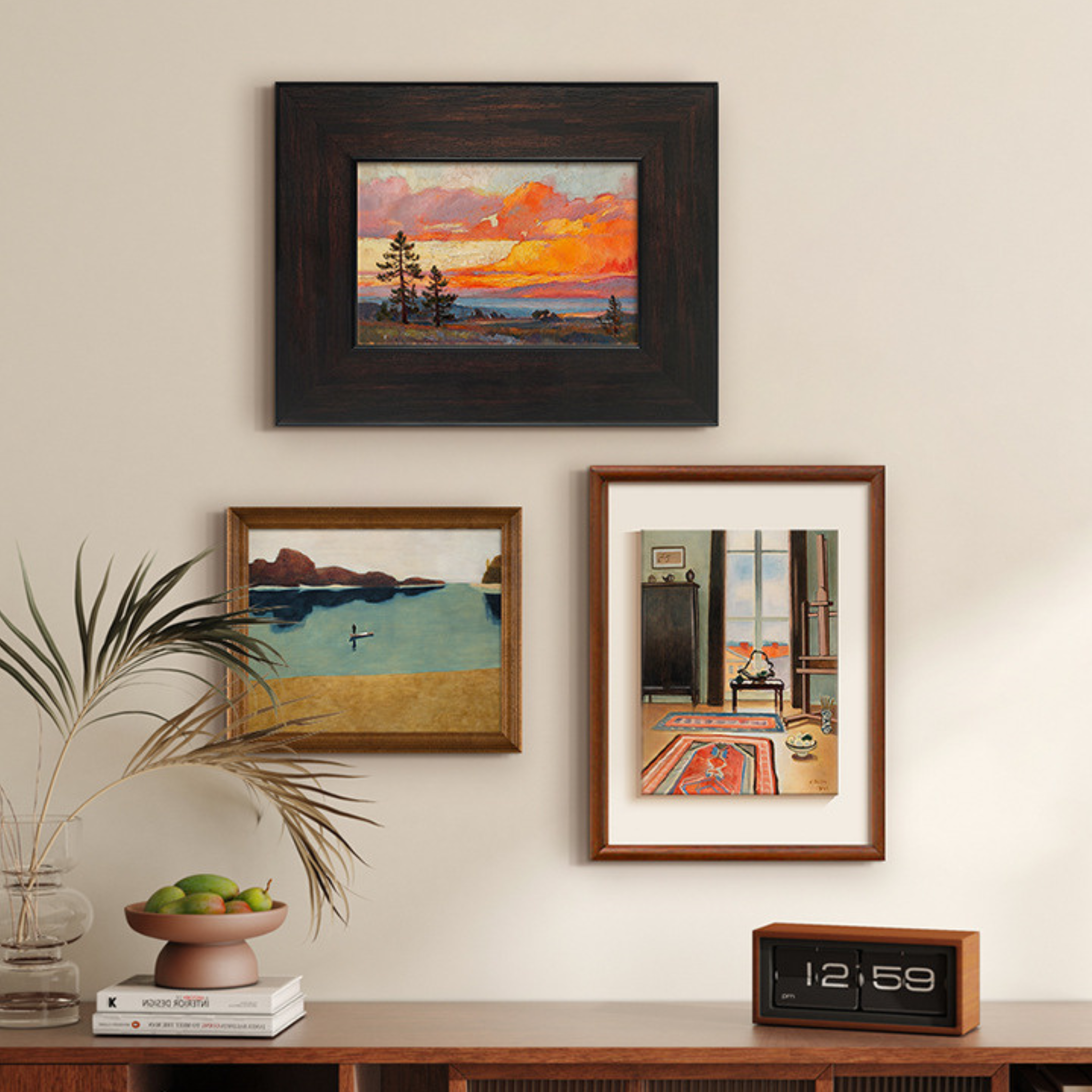 Three framed artworks on a wall above a wooden console table with decorative items in living room, bedroom and hallway