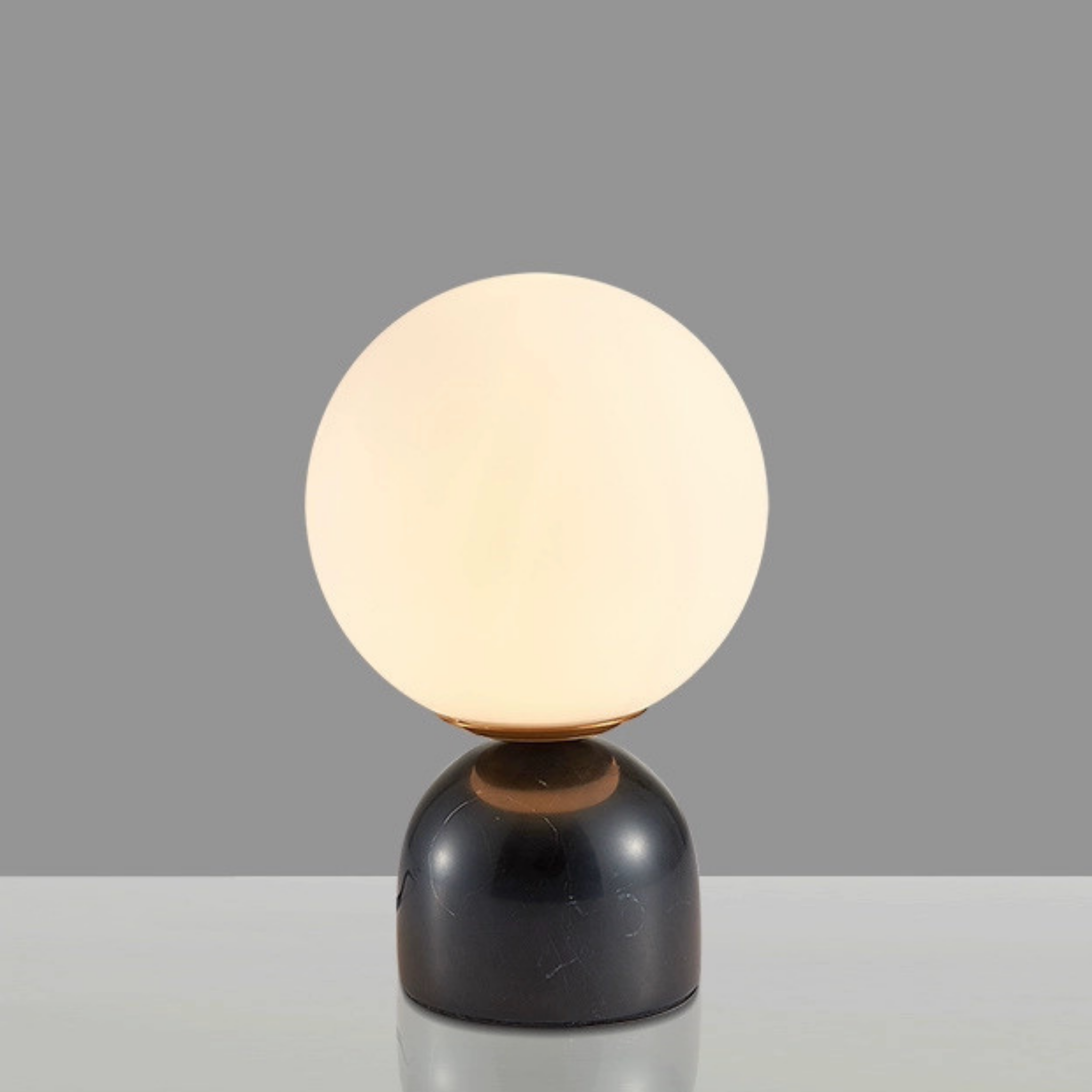 Luna Stone Lamp with black marble-effect base — smooth frosted glass sphere and warm illumination for modern interiors, KaShi Living
