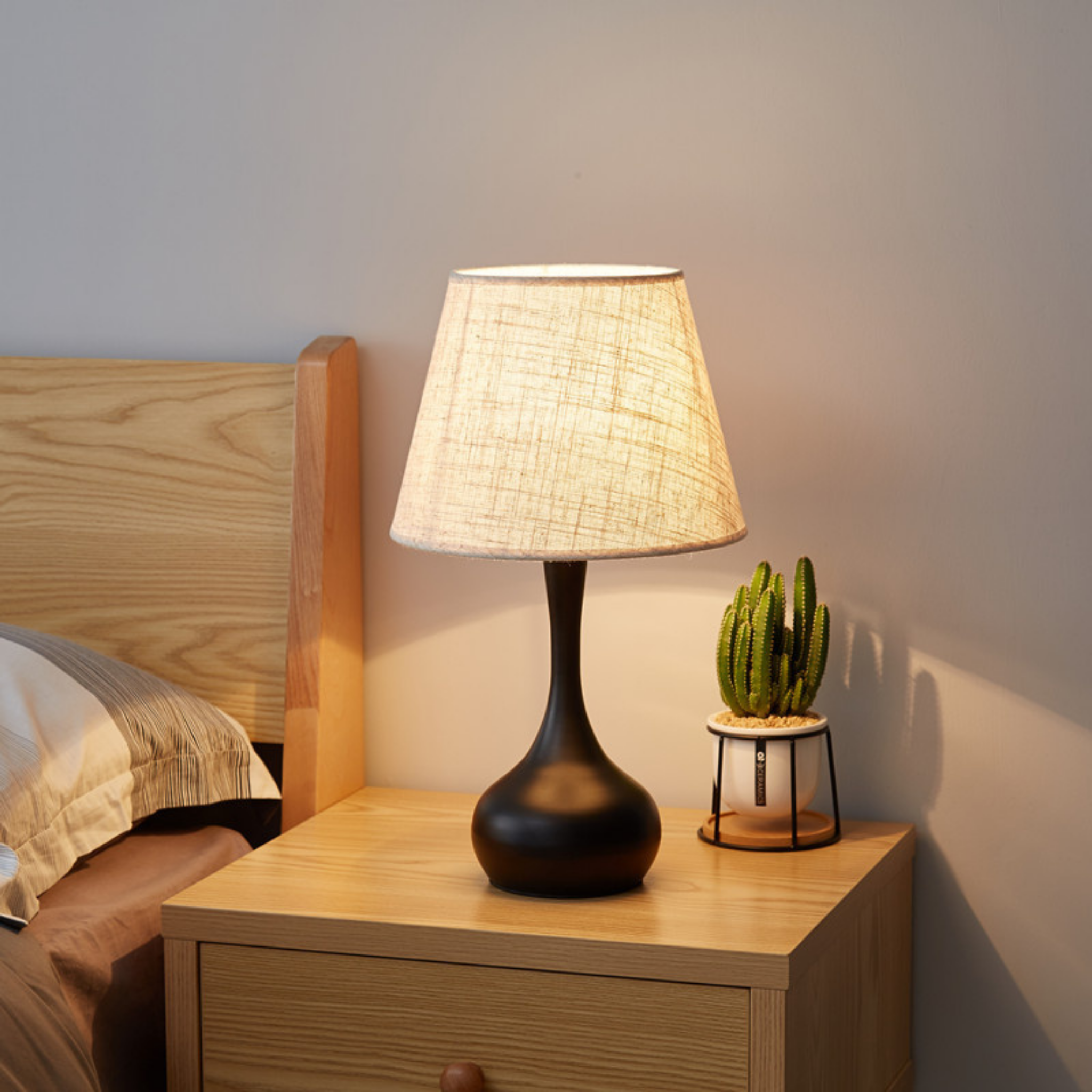 Noir Essence Lamp beside cactus décor — contemporary black base with linen shade, blending comfort and elegance for bedroom ambience