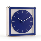 A blue freestanding table clock with a square frame and round dial, designed for UK shelves, desks, bedside tables and stylish everyday home décor.
