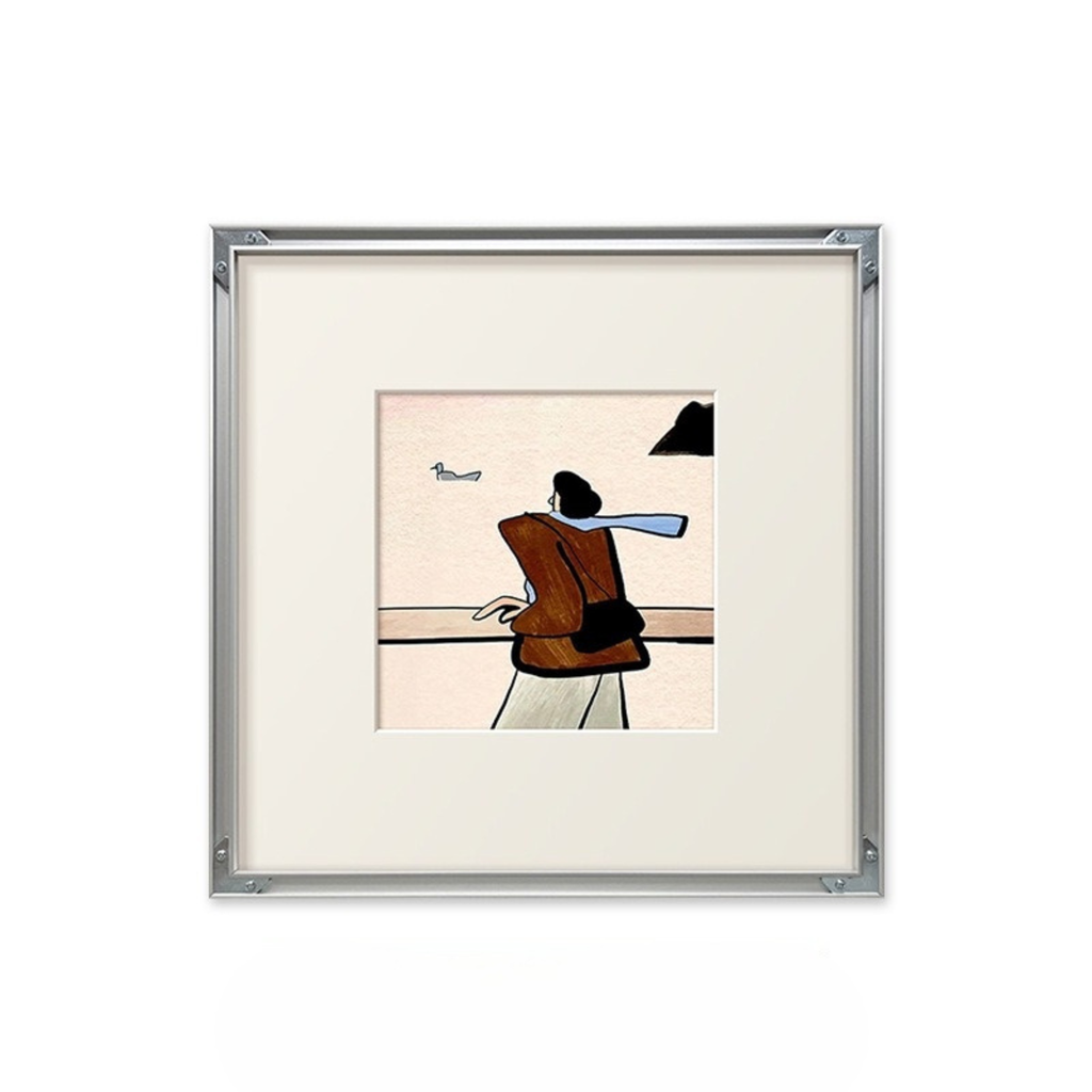 A soft coastal framed wall art print showing a quiet seaside figure, suited to UK bedrooms, hallways and calming gallery walls.
