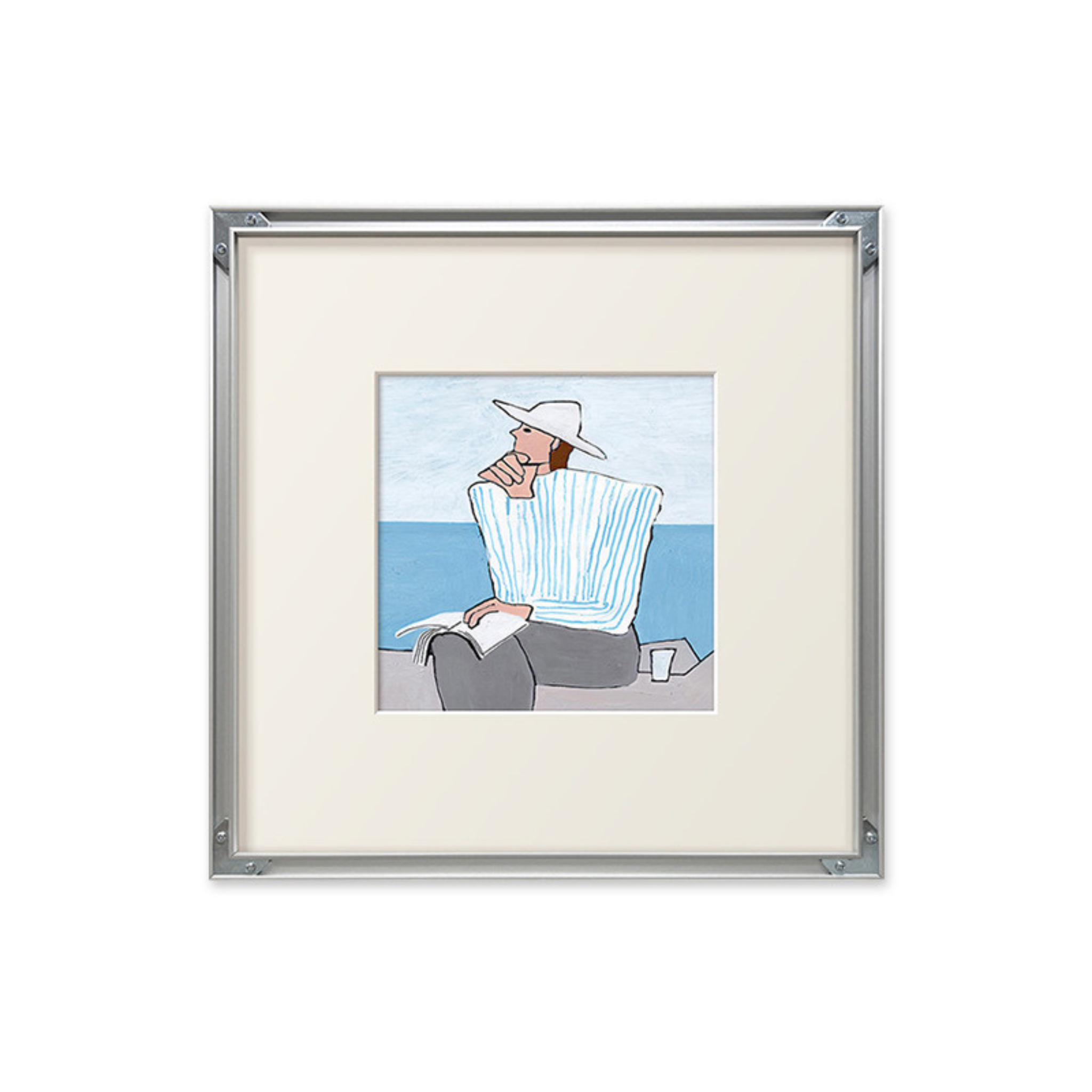 A soft coastal framed wall art piece featuring a seated figure by the sea, suited to UK bedrooms, living rooms and gallery walls.