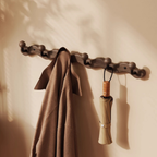 A walnut-tone wavy wall hook rack with four rounded hooks for UK hallways, bedrooms, cloakrooms and small-space coat, bag and key storage.